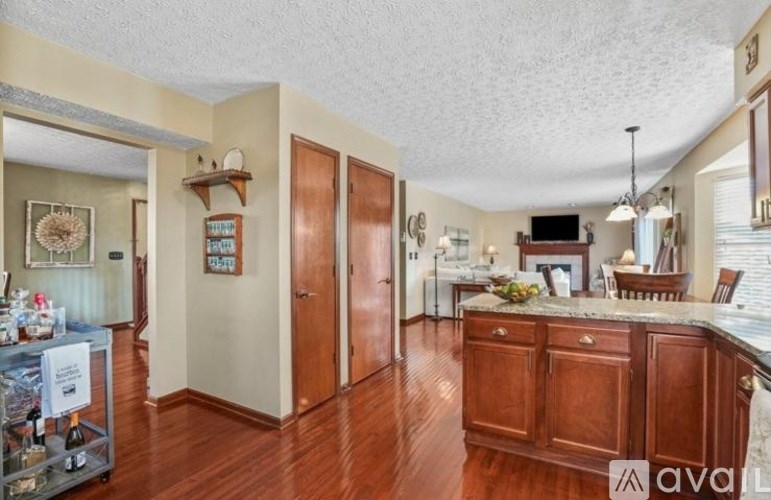 A kitchen with wooden cabinets and a marble countertop.