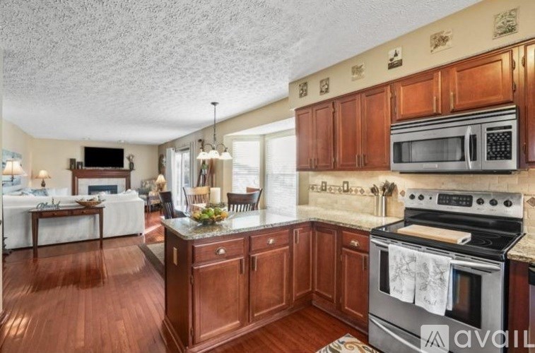 A kitchen with wooden cabinets and a stove top oven.