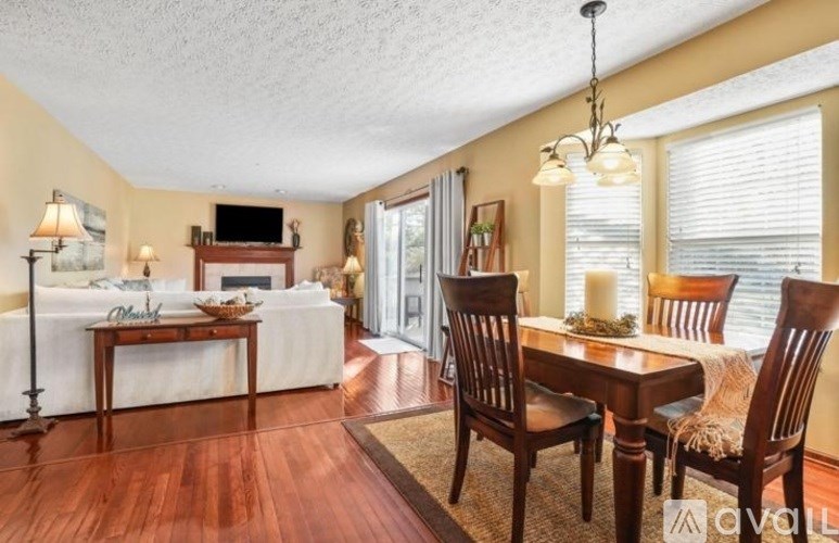 A living room with a white couch and a wooden table.