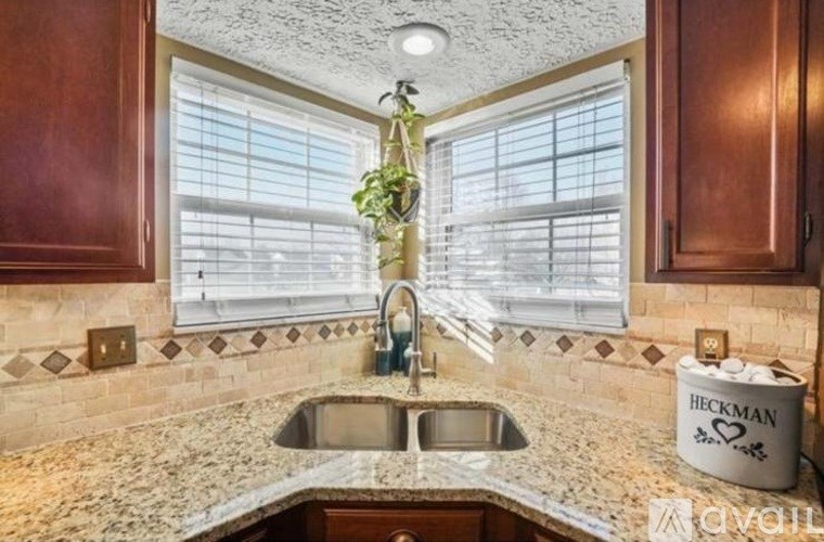 A kitchen with a sink and a window.