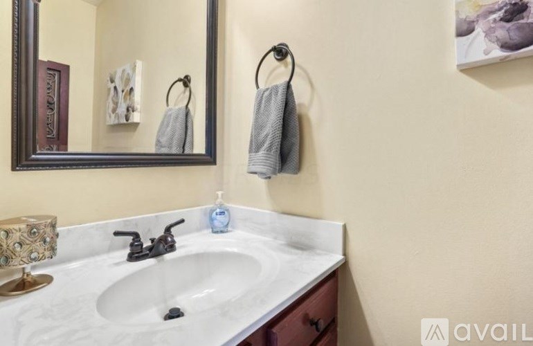 A bathroom with a white sink and a mirror.