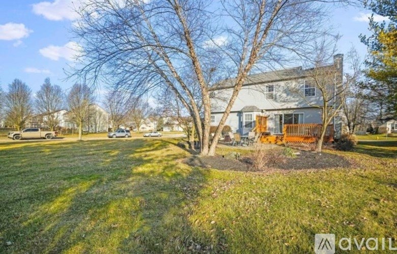 A house with a tree in front of it.