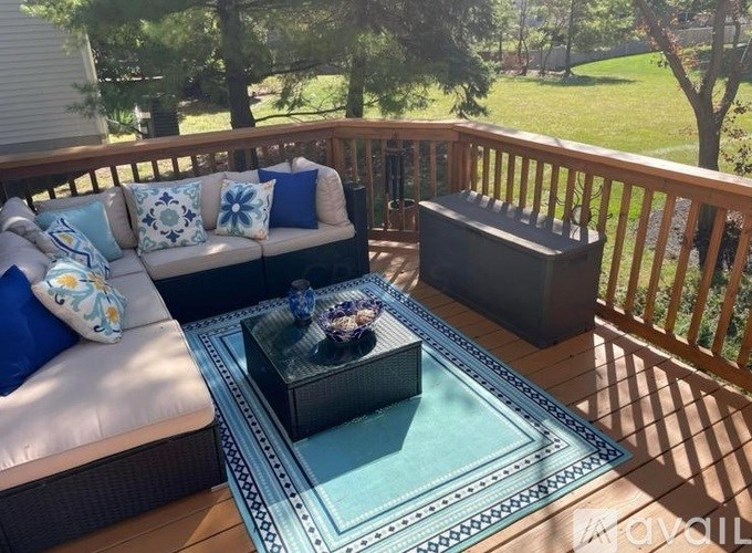 A patio with a couch, coffee table, and a fireplace.