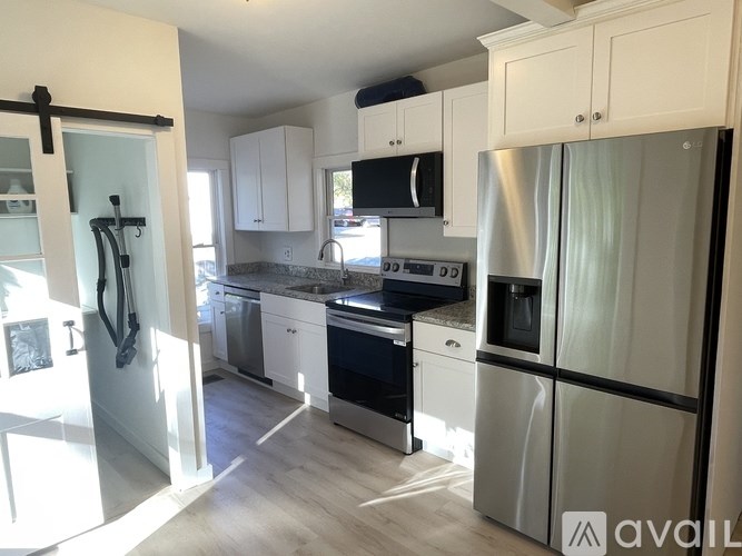 A kitchen with white cabinets and stainless steel appliances.