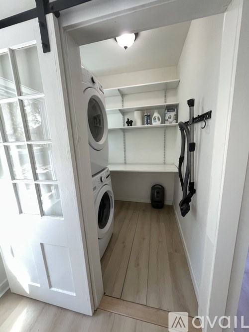 A small laundry room with a washer and dryer.