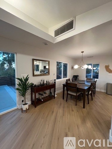 A dining room with a wooden table and chairs.