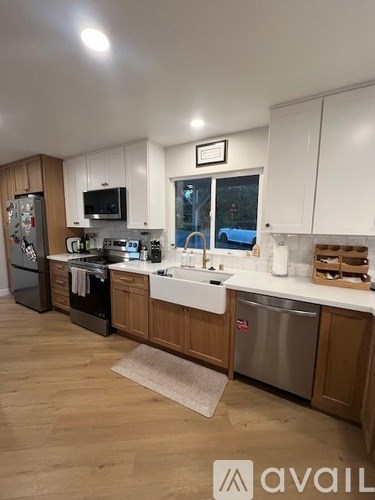 A kitchen with wooden cabinets and a fridge.