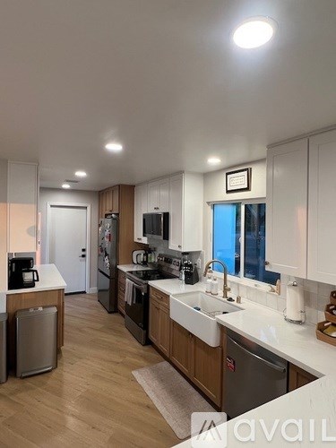 A kitchen with wooden cabinets and a white countertop.