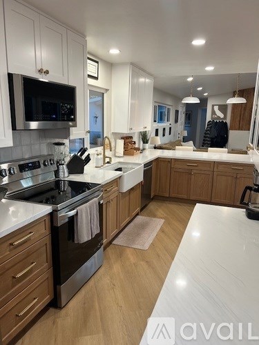 A kitchen with wooden cabinets and a white countertop.