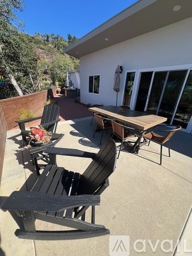 A patio with a table and chairs.