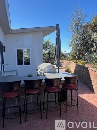 A patio with a table and chairs is set up outside a house.