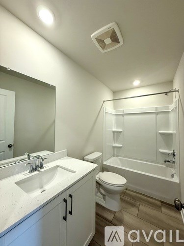 A bathroom with a sink, toilet, and bathtub.
