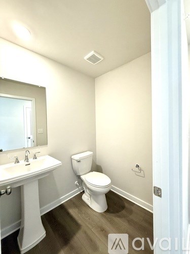 A white toilet sits next to a sink in a small bathroom.
