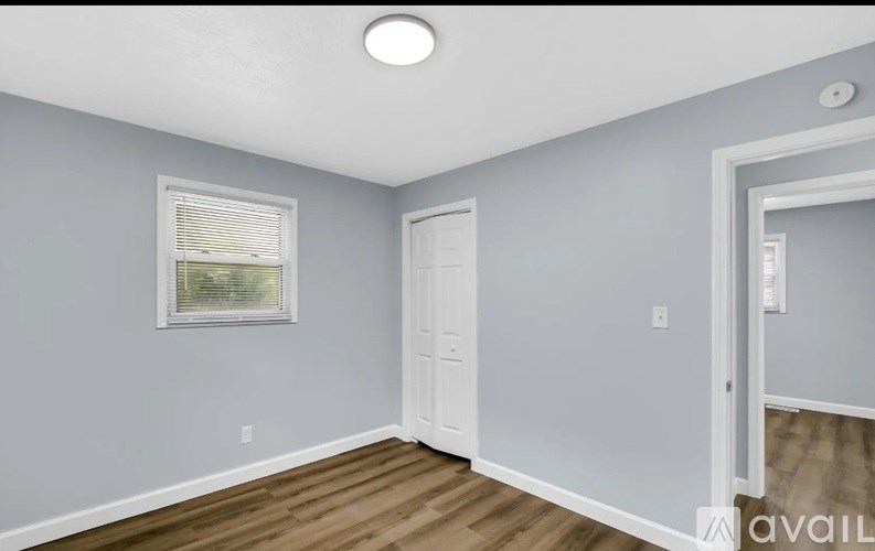 A room with a window and a door.