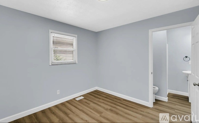 A room with a window and a door.