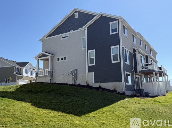 A two-story house with a balcony on the second floor.