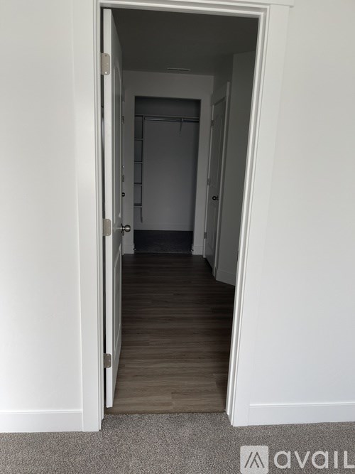 A hallway with a door at the end.