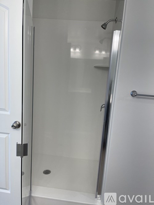 A glass shower door in a bathroom.