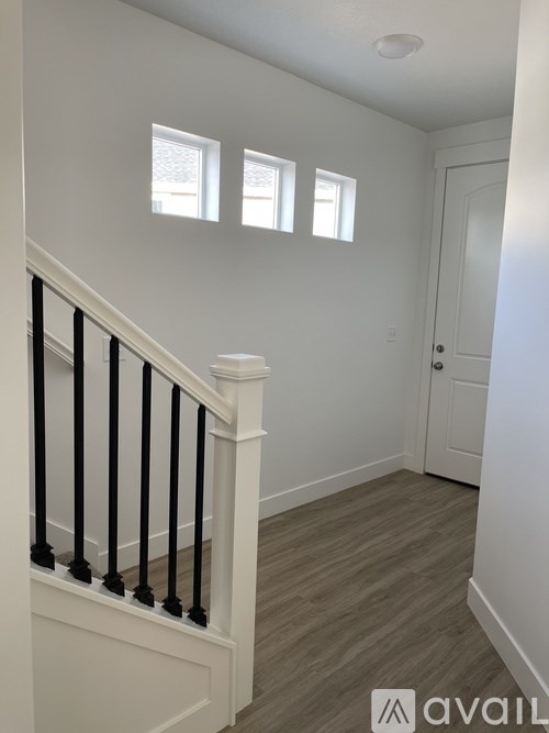 A white interior with a staircase leading to the second floor.