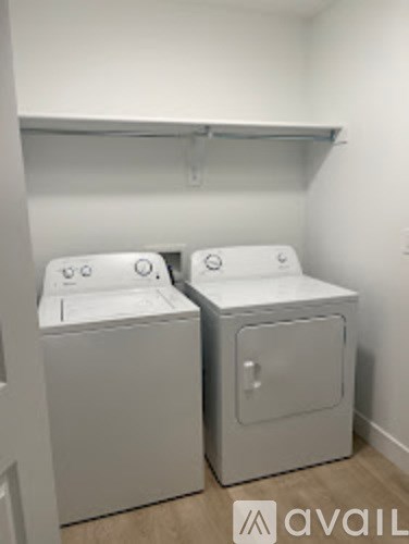 Two front loading washing machines in a laundry room.