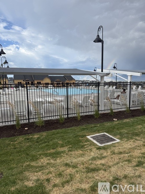 A pool area with a fence and a lamp post.