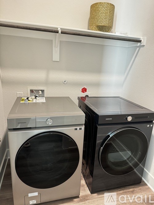 Two front loading washing machines in a laundry room.