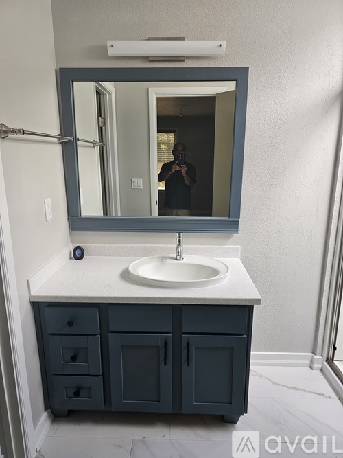 A bathroom with a sink and a mirror.