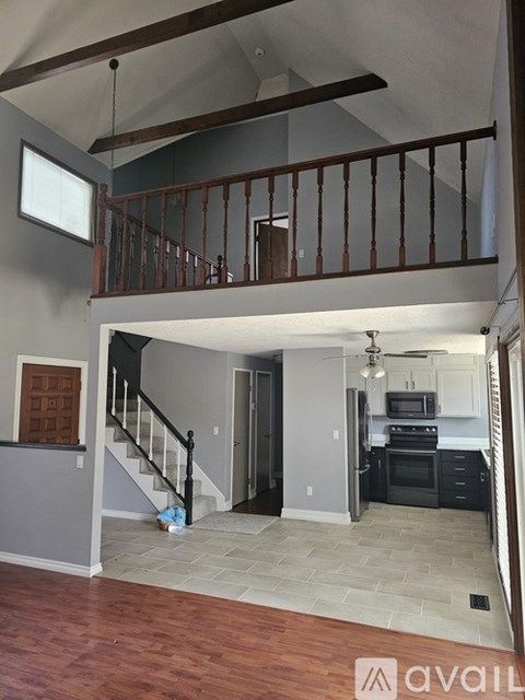 A kitchen with a stove top oven and a refrigerator.