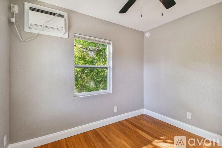 A room with a window and a ceiling fan.