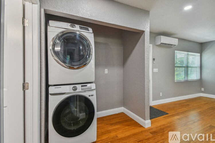 A washer and dryer are stacked on top of each other in a laundry room.