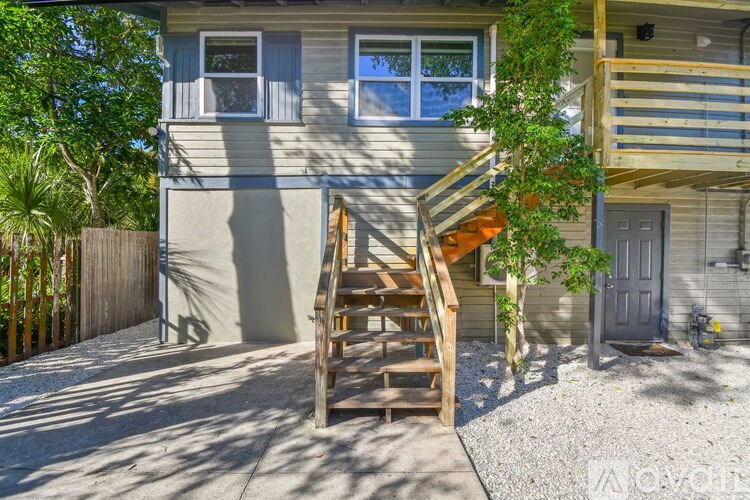 A house with a wooden staircase leading to the second floor.