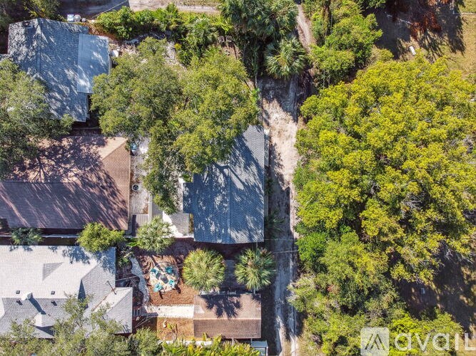 A bird's eye view of a residential area with houses and trees.