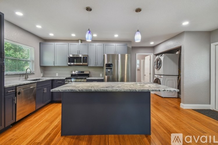 A modern kitchen with a large island in the center.
