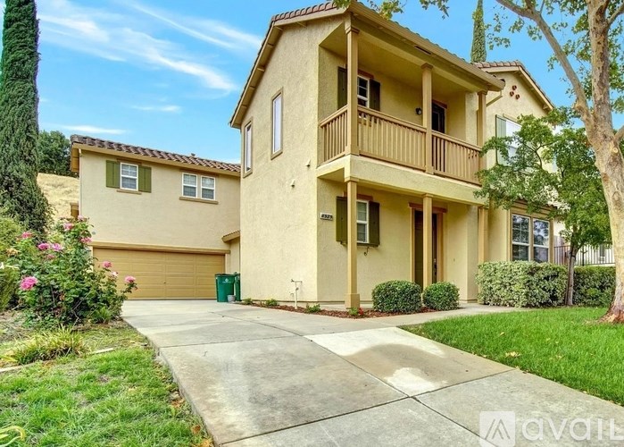 A two-story house with a balcony on the second floor.