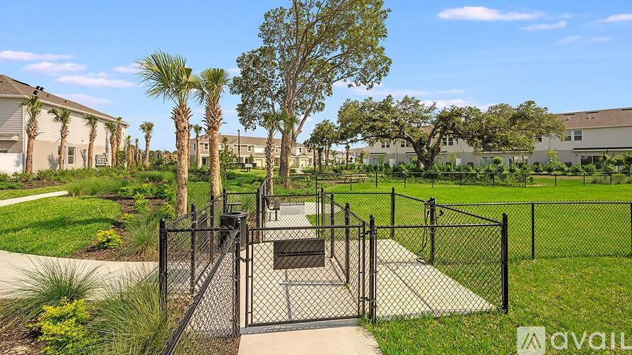 A gated entrance to a residential area with a fence and gate.
