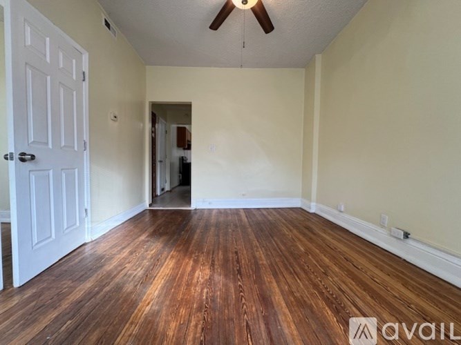 A room with wooden floors and a white door.