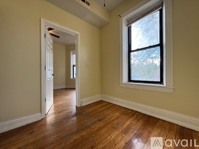 A room with wooden floors and a window.