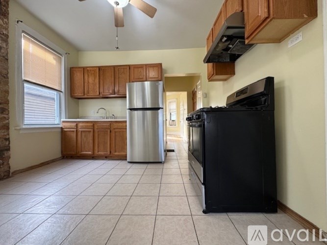 A kitchen with a black fridge and stove.