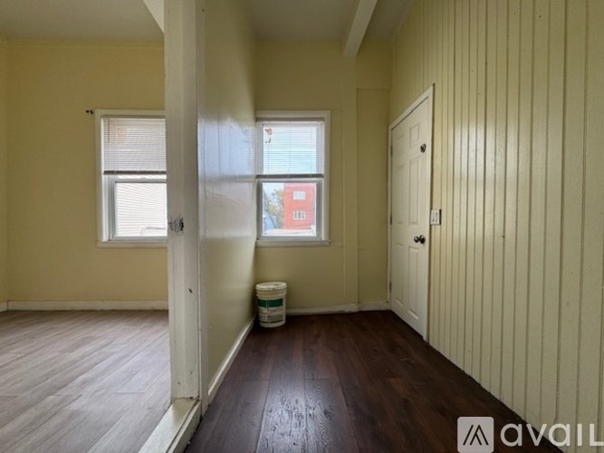 A room with wooden floors and a white door.