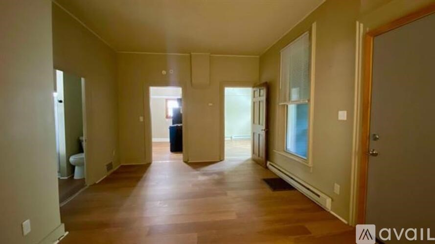A long hallway with a trash can in the middle.