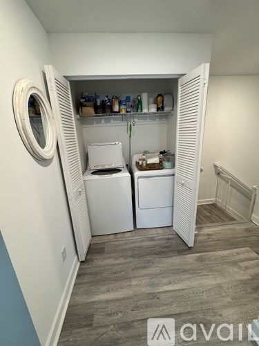 A small laundry room with a washer and dryer.