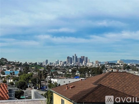 A cityscape with buildings and a clear sky.