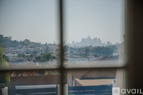 A view of a city skyline through a window with a blurred background.