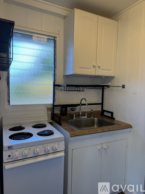 A kitchen with a stove and a sink.