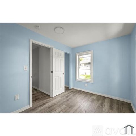 A room with blue walls and a white door.