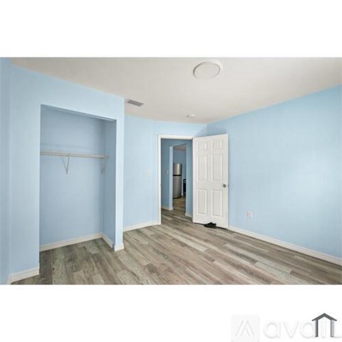 A room with a blue wall and a white door.