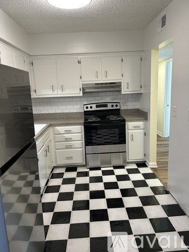 A black and white checkered floor in a kitchen.
