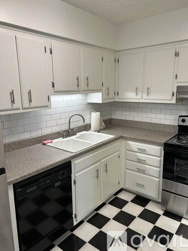 A kitchen with black and white checkered floor.