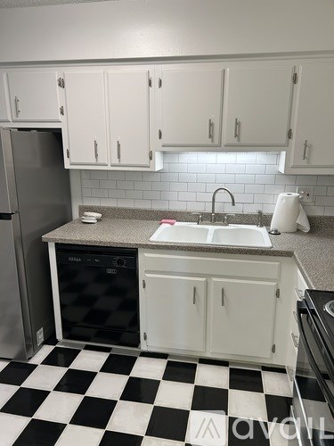 A kitchen with black and white checkered floor.