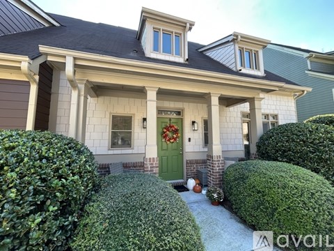 A house with a green door and a wreath on it.